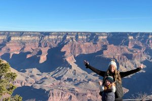 mom and son standing at the grand canyon